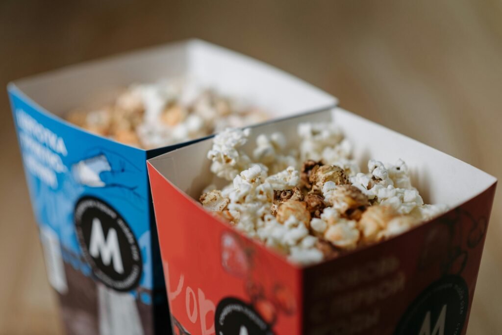 A close-up view of popcorn in red and blue boxes, perfect for movie nights.