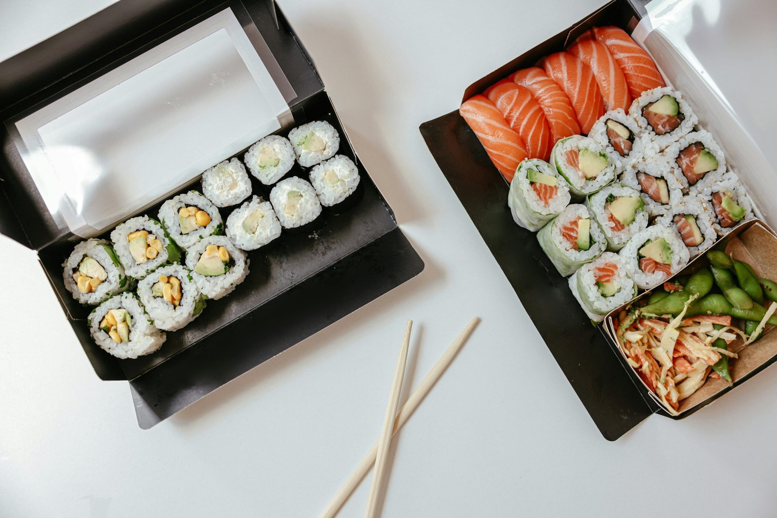 Variety of sushi rolls and sashimi with edamame, perfect for Japanese cuisine enthusiasts.